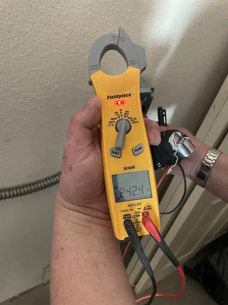 Voltage testing with clamp meter during Electrical Installation Services in Hugo